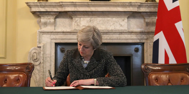 LONDON, ENGLAND - MARCH 28: British Prime Minister Theresa May in the cabinet office signs the official letter to European Council President Donald Tusk invoking Article 50 and the United Kingdom's intention to leave the EU on March 28, 2017 in London, England. After holding a referendum in June 2016 the United Kingdom voted to leave the European Union, the signing of Article 50 now officially triggers that process. (Photo by Christopher Furlong - WPA Pool/Getty Images)