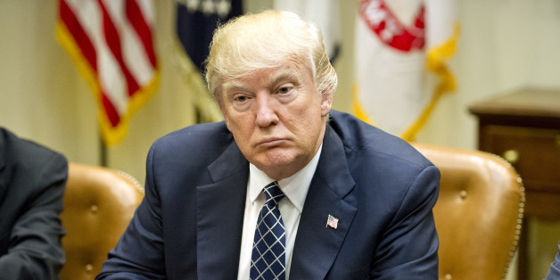 U.S. President Donald Trump listens during a listening session with the Fraternal Order of Police in the Roosevelt Room of the White House in Washington, D.C., U.S., on Tuesday, March 28, 2017. Trump will sign an executive order Tuesday that will in part reverse two main planks of federal efforts under President Barack Obama to adapt to climate change, a senior White House official told reporters. Photographer: Ron Sachs/Pool via Bloomberg
