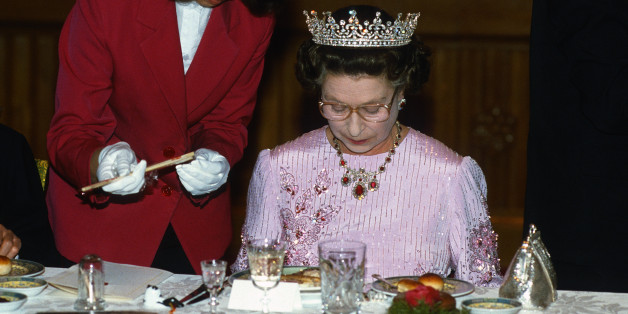 PEKING, CHINA - OCTOBER 13: Queen Elizabeth ll is offered chopsticks as she studies her food during a State Banquet on October 13 ,1986 in Peking, China. The Queen is wearing the tiara known as 'Granny's Tiara' and a pink dress decorated with tree peony blossom, the national flower of China, designed by Ian Thomas. (Photo by Anwar Hussein/Getty Images)