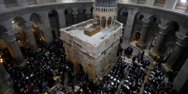 Christian clergymen and other guests attend a ceremony marking the end of restoration work on the site of Jesus's tomb, in the Church of the Holy Sepulchre, in Jerusalem's Old City March 22, 2017. REUTERS/Menahem Kahana/Pool