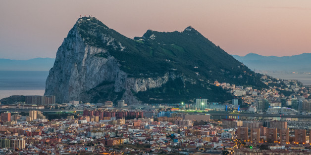 View of the Rock of Gibraltar as seen from the Sierra Carbonera Mountains of Cadiz, Spain. The Spanish border town of La LÃnea de la Concepción can be seen in the foreground. On the horizon can be seen the Rif Mountains of Morocco and the coastline of North Africa.