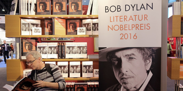 FRANKFURT AM MAIN, GERMANY - OCTOBER 19: A man reads a book about Bob Dylan at the 2016 Frankfurt Book Fair (Frankfurter Buchmesse) on October 19, 2016 in Frankfurt am Main, Germany. The 2016 fair, which is among the world's largest book fairs, will be open to the public from October 19-23. (Photo by Hannelore Foerster/Getty Images)