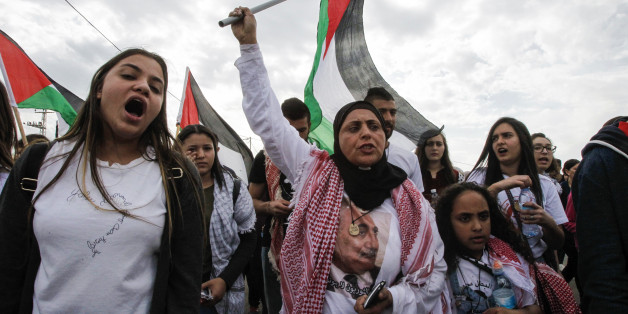 A female demonstrator waves a Palestinian flag during a demonstration marking Land Day on March 30, 2017 in the northern Arab-Israeli village of Deir Hanna in the northern Galilee region.Land Day marks the killing of six Arab Israelis during 1976 demonstrations against Israeli confiscations of Arab land. / AFP PHOTO / HAZEM BADER (Photo credit should read HAZEM BADER/AFP/Getty Images)