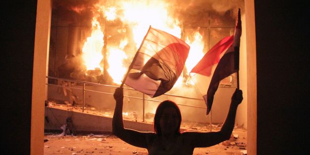 TOPSHOT - One of the hundreds of demonstrators protesting against the approval of a constitutional amendment for presidential reelection who broke into the Congress building, battering down entrances and fences and shattering windows, and started to set fires inside, in Asuncion on March 31, 2017.Paraguayan senators on Friday approved a contested law allowing President Horacio Cartes to seek reelection in 2018, prompting furious protesters to break into the legislature, ransacking lawmakers' off