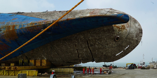 MOKPO, SOUTH KOREA - APRIL 1: In this handout photo released by the South Korean Ministry of Oceans and Fisheries, The sunken ferry Sewol sitting on a semi-submersible transport vessel arrived at a port in Mokpo on April 1, 2017 in Mokpo, South Korea. The Sewol sank off the Jindo Island in April 2014 leaving more than 300 people dead and nine of them still remain missing. (Photo by South Korean Ministry of Oceans and Fisheries via Getty Images)