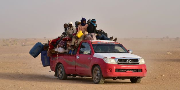 West African people coming back to Niger after fleeing Libya due to armed groups, arrive on a pick up in Agadez, northern Niger, on March 31, 2017, following their failed attempt to reach Europe by crossing the Mediterranean sea. / AFP PHOTO / ISSOUF SANOGO (Photo credit should read ISSOUF SANOGO/AFP/Getty Images)