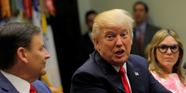 U.S. President Donald Trump (C) meets with members of the National Association of Manufacturers, including National Association of Manufacturers CEO Jay Timmons (L) and Matrix 4 CEO Patricia Miller (R), at the White House in Washington, U.S. March 31, 2017. REUTERS/Jonathan Ernst
