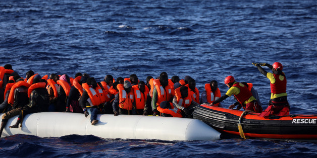 Rescuers help migrants on an overcrowded plastic raft board a RHIB during a search and rescue operation by Spanish NGO Proactiva Open Arms, in central Mediterranean Sea, some 22 nautical miles north of the Libyan town of Sabratha, April 1, 2017. REUTERS/Yannis Behrakis