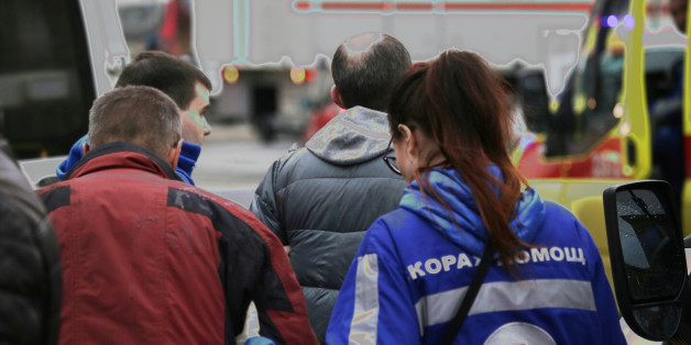 An injured person is helped by emergency services outside Sennaya Ploshchad metro station, following explosions in two train carriages at metro stations in St. Petersburg, Russia April 3, 2017. REUTERS/Anton Vaganov