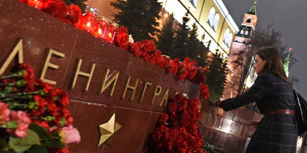 A woman lays flowers in memory of victims of the blast in the Saint Petersburg metro at a memorial stone reading Leningrad by the Kremlin wall in central Moscow on April 3, 2017.
Russia opened a probe into a suspected 'act of terror' Monday after 10 people were killed and dozens more injured in a blast that rocked the Saint Petersburg metro. / AFP PHOTO / Vasily MAXIMOV (Photo credit should read VASILY MAXIMOV/AFP/Getty Images)