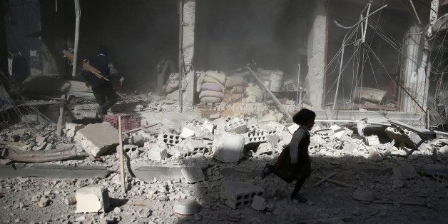 A girl runs past a damaged site after an airstrike in the besieged rebel-held town of Douma, eastern Ghouta in Damascus, Syria November 2, 2016. REUTERS/Bassam Khabieh TPX IMAGES OF THE DAY