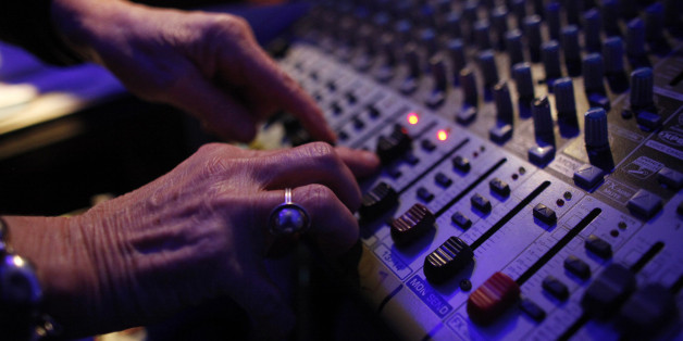 DJ Wika Szmyt controls the sound mixer as she plays music at a club in Warsaw January 4, 2012. Szmyt, 73, spends her retirement days behind a DJ console watching people dance to her rhythms. She plays disco, rumba or samba for a mostly elderly audience because she feels she is giving them a new take at life. DJ Wika plays in a Warsaw club three days a week but has also been involved in other musical projects, including parties where she plays for a younger and more demanding audience. REUTERS/Kacper Pempel (POLAND - Tags: SOCIETY ENTERTAINMENT)