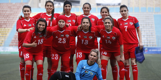 Palestinian female football players (in red) are seen during a qualifying match against Thailand for the Asian Women football Cup in the West Bank town of al-Ram on April 3, 2017. The Palestinian women's football team saw a crushing defeat in their first match in Asian Cup qualifiers -- a 6-0 loss to Thailand -- but for captain Claudie Salameh, the score means little. 'Playing football for girls in Palestine is an enormous challenge,' she said after the match. Palestinian women football players