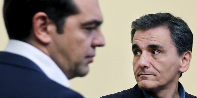 Newly-appointed Finance Minister Euclid Tsakalotos looks on during his swearing in ceremony as Greek Prime Minister Alexis Tsipras (L) stands next to him at the Presidential Palace in Athens, Greece July 6, 2015. Greece's top negotiator in aid talks with creditors, Euclid Tsakalotos, sworn in as finance minister on Monday after the resignation of Yanis Varoufakis. REUTERS/Alkis Konstantinidis TPX IMAGES OF THE DAY