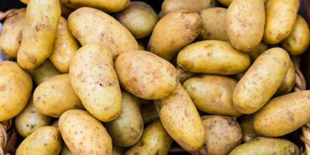 Fresh organic potatoes resting in the wooden basket