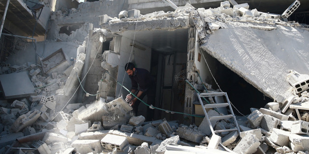 A man removes rubble at a damaged site after airstrikes in the rebel held besieged Douma neighborhood of Damascus, Syria April 4, 2017. REUTERS/Bassam Khabieh