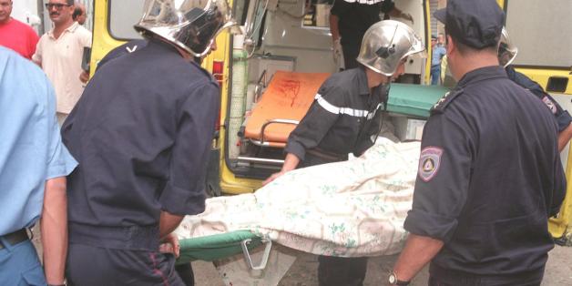 ALGIERS, ALGERIA: Firemen carry the body of one of the victims of a bombing in central Algiers 31 August. The bomb exploded at the marketplace of the busy western district of Bab el Oued. The blast took place mid-morning killing at least 17 people and wounding 61. An estimated 80 000 people have died in violence since armed Moslem fundamentalists began a guerilla war in January 1992. (Photo credit should read AFP/Getty Images)