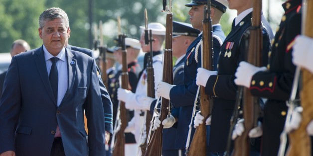 Belgium's Defense Minister Steven Vandeput walks past an honor guard as he arrives to attend a meeting of defense ministers of the Global Coalition to Counter ISIL at Joint Base Andrews in Maryland, July 20, 2016. / AFP / SAUL LOEB (Photo credit should read SAUL LOEB/AFP/Getty Images)