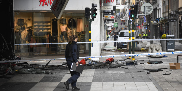 A police officer walks April 8, 2017 at the site where a stolen truck was driven through a crowd and crashed into the Ahlens department store in central Stockholm the day before.Fifteen people, including children, were also injured, nine seriously, health authorities said. / AFP PHOTO / Jonathan NACKSTRAND (Photo credit should read JONATHAN NACKSTRAND/AFP/Getty Images)