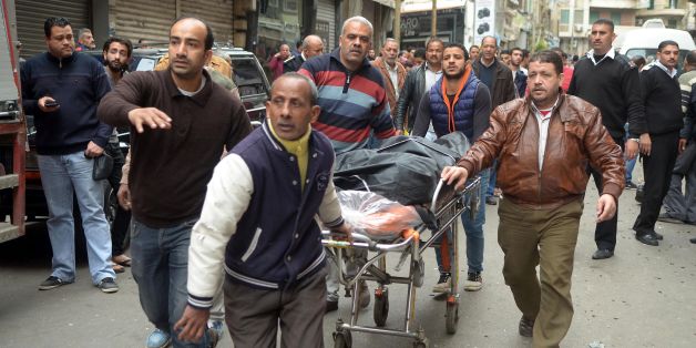 Egyptians wheel away a body near a church in Alexandria after a bomb blast struck worshippers gathering to celebrate Palm Sunday on April 9, 2017.The Interior ministry said Coptic Pope Tawadros II was inside the church leading a Palm Sunday service when the suicide bomber was stopped by police outside and blew himself up.A church official said Tawadros had already left the church when the bombing took place. / AFP PHOTO / STRINGER (Photo credit should read STRINGER/AFP/Getty Images)