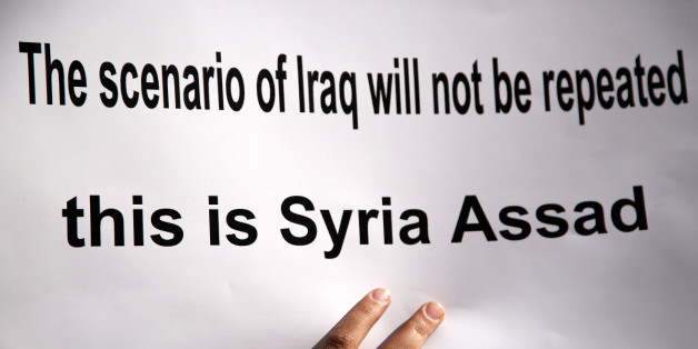 A placard is pictured during a protest against American airstrikes in Syria, in front of the United Nations (UN) building in Damascus, Syria April 8, 2017. REUTERS/Omar Sanadiki