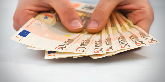 Hands with stack of fifty euro banknotes.