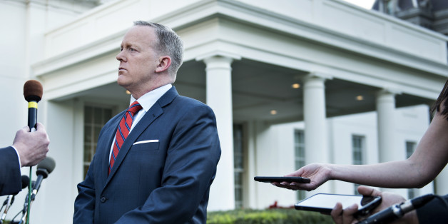 White House Press Secretary Sean Spicer speaks to a reporter about a comparison he made between Syria's President Bashar al-Assad and Hitler during an earlier press briefing at the White House April 11, 2017 in Washington, DC.Spicer apologized Tuesday for 'insensitive' remarks during a press briefing in which he asserted that Adolf Hitler did not use chemical weapons on his own people. / AFP PHOTO / Brendan Smialowski (Photo credit should read BRENDAN SMIALOWSKI/AFP/Getty Images)