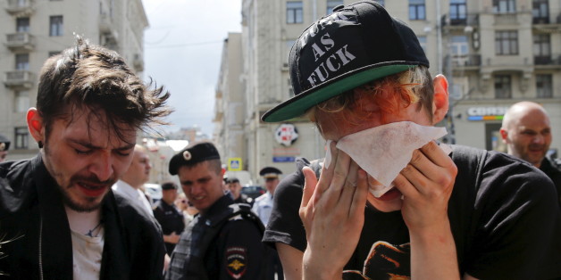 Gay rights activists react after being pepper sprayed by anti-gay protesters during an LGBT (lesbian, gay, bisexual, and transgender) community rally in central Moscow, Russia, May 30, 2015. REUTERS/Maxim Shemetov TEMPLATE OUT