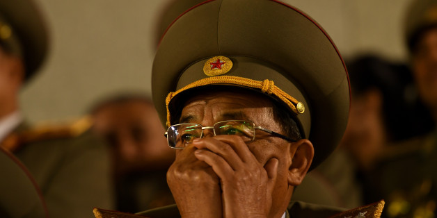 PYONGYANG, NORTH KOREA - MAY 10: An older, decorated military official watches an evening patriotic program in Kim Il Sung Square in Pyongyang, North Korea on May 1, 2016. The day was full of two patriotic parades marking the culmination of the Seventh Congress of the Workers' Party which ended yesterday. The Party cemented Kim Jong Un's leadership and yesterday named him as Party Chairman. He attended today's dayside parade waving from a balcony to a roaring crowd of worshipers. This e