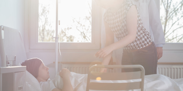 Image of woman visiting suffering from carcinoma child at hospital
