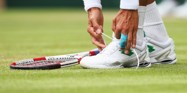 LONDON, ENGLAND - JUNE 26: a detail shot of Lukas Rosol of Czech Republic tying his shoelace during his Gentlemen's Singles second round match against Rafael Nadal of Spain on day four of the Wimbledon Lawn Tennis Championships at the All England Lawn Tennis and Croquet Club at Wimbledon on June 26, 2014 in London, England. (Photo by Jan Kruger/Getty Images)