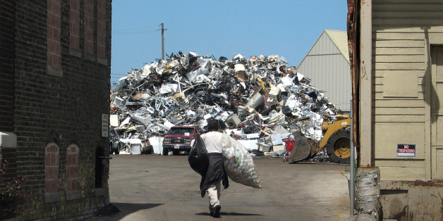 A scrapper heads toward a mountain of metal at a scrap yard in Milwaukee, Wisconsin, U.S. June 30, 2016. Picture taken June 30, 2016. REUTERS/Brendan O'Brien
