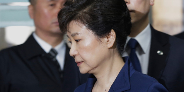 South Korea's ousted president Park Geun-Hye (front) arrives for questioning on her arrest warrant at the Seoul Central District Court in Seoul on March 30, 2017.Park arrived at court on March 30 for a hearing to decide whether she should be arrested over the corruption and abuse of power scandal that brought her down. / AFP PHOTO / POOL / Ahn Young-joon (Photo credit should read AHN YOUNG-JOON/AFP/Getty Images)
