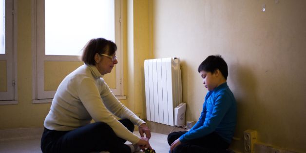 An assistant takes care of Jules, a 8-year-old autistic boy, on March 24, 2017 in Courbevoie, north-west of Paris, at the Lud'Eveil center for children with autism, which uses the '3i' developmental method, based on games . The ninth annual World Autism Awareness Day will be marked on April 2, 2017. / AFP PHOTO / MARTIN BUREAU (Photo credit should read MARTIN BUREAU/AFP/Getty Images)