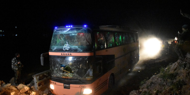 Buses carrying Syrians, evacuated from two besieged government-held towns of Fuaa and Kafraya, arrive at Aleppo's Ramousseh crossing as they make their way to a makeshift shelter in Jibrin on the eastern outskirts of Aleppo, on April 15, 2017, as part of a deal between the opposition and the Syrian government. / AFP PHOTO (Photo credit should read /AFP/Getty Images)
