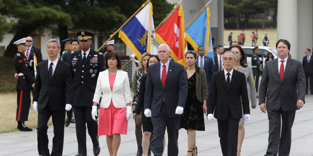 U.S. Vice President Mike Pence, center, and his wife Karen, center left, inspect hour guard upon their arrival at the National Cemetery in Seoul, South Korea, Sunday, April. 16, 2017. REUTERS/Ahn Young-joon/Pool