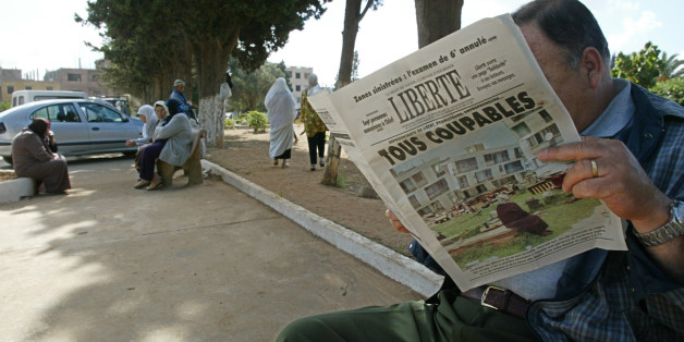 An Algerian reads the 26 May 2003 'Liberte' newspaper titled ' All guilty' 26 May 2003, at the entrance of El Alia cemetery in Algiers. The Algerian government scrambled Monday to dispel criticiem it has dragged its heels in helping victims of last week's deadly quake, as Islamic radicals took advantage of the widespread anger towards the authorities and stepped in to fill the void. AFP PHOTO/PHILIPPE DESMAZES (Photo credit should read PHILIPPE DESMAZES/AFP/Getty Images)