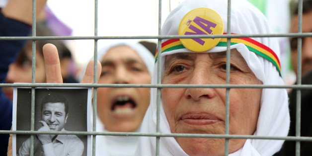 A supporter holds a portrait of Selahattin Demirtas, detained leader of Turkey's pro-Kurdish opposition Peoples' Democratic Party (HDP), during a rally for the upcoming referendum in the southeastern city of Diyarbakir, Turkey, April 15, 2017. REUTERS/Sertac Kayar