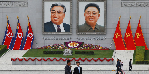 People walk in front of portraits of North Korea founder Kim Il Sung and late leader Kim Jong Il in central Pyongyang, North Korea April 16, 2017. REUTERS/Damir Sagolj