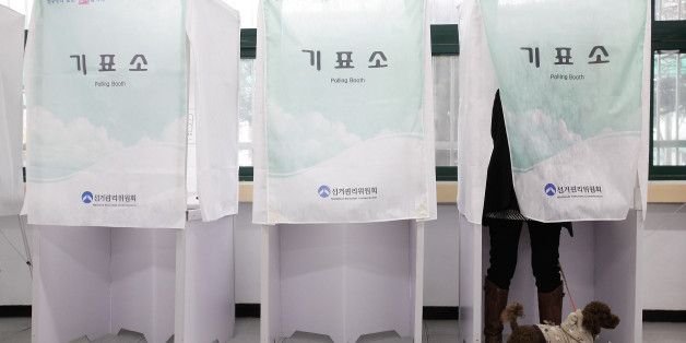 SEOUL, SOUTH KOREA - APRIL 11: A South Korean woman casts her vote for new members of the National Assembly in a polling station at the Yuido Elementary School on April 11, 2012 in Seoul, South Korea. The poll is expected to be a tight contest between the two main South Korean parties, but neither New Frontier Party or its main rival, the Democratic United Party are likely to win a majority in the 300 seat assembly. (Photo by Chung Sung-Jun/Getty Images)