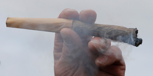 A man holds a marijuana joint during the annual 4/20 marijuana rally on Parliament Hill in Ottawa, Ontario, Canada, April 20, 2017. REUTERS/Chris Wattie