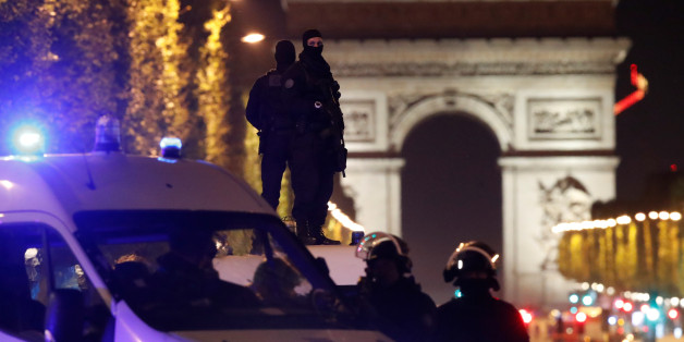 Masked police stand on top of their vehicle on the Champs Elysees Avenue after a policeman was killed and two others were wounded in a shooting incident in Paris, France, April 20, 2017. REUTERS/Christian Hartmann TPX IMAGES OF THE DAY