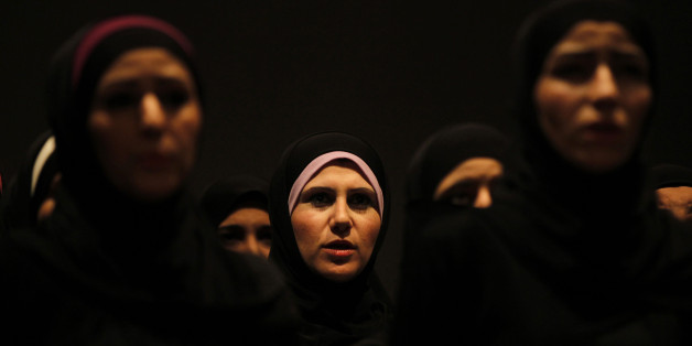 Syrian refugee women perform the play "The Syria Trojan Women" in Amman December 18, 2013. Syrian actress Nanda Mohammad trained Syrian refugee women for six weeks to reinterpret "The Trojan Women", a tragedy by Greek playwright Euripides on the Greeks' treatment of Trojan women after the fall of Troy. "The Syria Trojan Women" traces the parallels between the fates of the women of Troy and Syrian women refugees fleeing the violence in their country. REUTERS/Muhammad Hamed (JORDAN - Tags: CONFLI