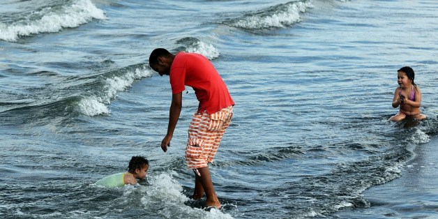 TO GO WITH AFP STORY BY ABDELLAH CHEBALLAHAlgerian children play in the waves at the Sablettes beach on Algiers' seafront promenade on May 31, 2014. Algerian authorities plan to redevelop the Bay of Algiers by 2030 with numerous renovation and expansion projects. AFP PHOTO/FAROUK BATICHE (Photo credit should read FAROUK BATICHE/AFP/Getty Images)
