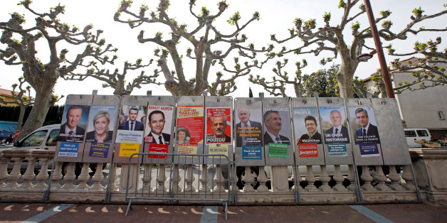 Campaign posters of the 11 candidates who run in the 2017 French presidential election are seen in Le Soler, near Perpignan, France April 15, 2017. (L-R) Debout La France group candidate Nicolas Dupont-Aignan, French National Front (FN) political party leader Marine Le Pen, head of the political movement En Marche! (Onwards!) Emmanuel Macron, French Socialist party candidate Benoit Hamon, France's extreme-left Lutte Ouvriere political party (LO) leader Nathalie Arthaud, Anti-Capitalist Party (NPA) presidential candidate Philippe Poutou, "Solidarite et Progres" (Solidarity and Progress) party candidate Jacques Cheminade, lawmaker and independent candidate Jean Lassalle, candidate of the French far-left Parti de Gauche Jean-Luc Melenchon, UPR candidate Francois Asselineau and the Republicans political party candidate Francois Fillon. REUTERS/Jean-Paul Pelissier
