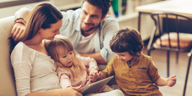 Close up of a happy young family having good time together.