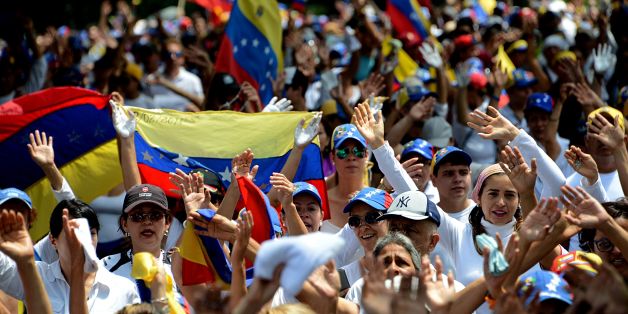 Venezuelan opposition activists march in a quiet show of condemnation of the government of President NIcolas Maduro, in the border state of Tachira-San Cristobal, on April 22, 2017. Venezuelans gathered Saturday for 'silent marches' against President Nicolas Maduro, a test of his government's tolerance for peaceful protests after three weeks of violent unrest that has left 20 people dead. / AFP PHOTO / GEORGE CASTELLANOS (Photo credit should read GEORGE CASTELLANOS/AFP/Getty Images)