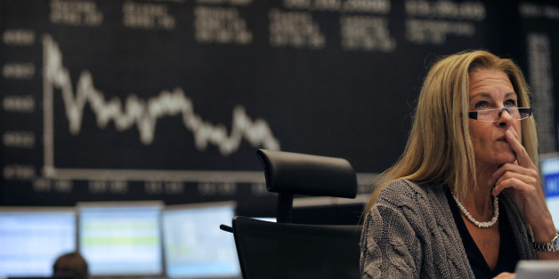 A share trader checks share prices as she sits behind her trading terminals at the trading floor of the German stock exchange in Frankfurt, October 20, 2008. REUTERS/Kai Pfaffenbach(GERMANY)