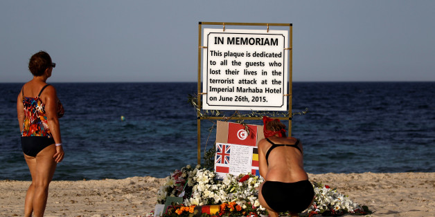 Tourists pay their respects at a plaque dedicated to victims on the beach of the Imperial Marhaba resort, on the first anniversary of an attack by a gunman at the hotel in Sousse, Tunisia June 26, 2016. REUTERS/Zohra Bensemra