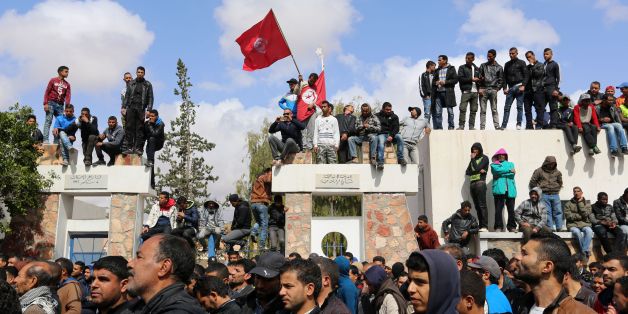 Tunisians wave their national flag as they take part in a general strike against marginalization and to demand development and employment on April 11, 2017, in Tataouine, south of Tunisia. / AFP PHOTO / FATHI NASRI (Photo credit should read FATHI NASRI/AFP/Getty Images)